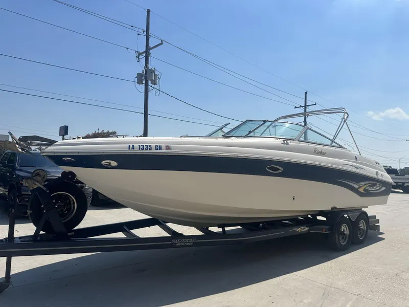 Slide: The Image of 2003 Rinker 282 Captiva boat on a trailer in a parking lot. - 5