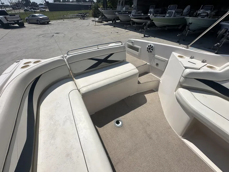 Slide: The Image of 2003 Rinker 282 Captiva boat interior with seating and cup holders. - 9