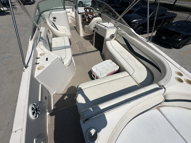 Slide: The Image of 2003 Rinker 282 Captiva boat interior with white seating and steering console. - 8