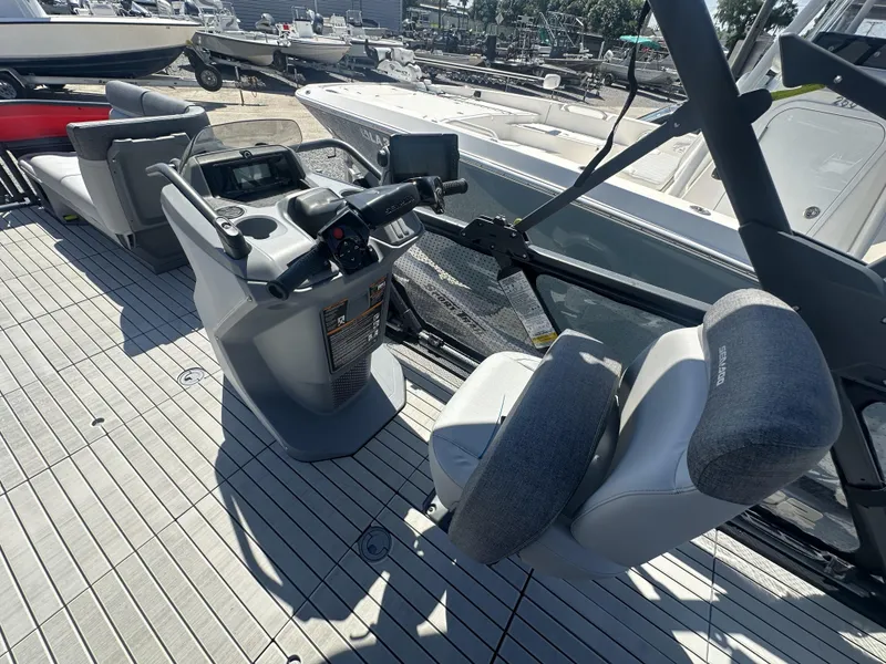 Slide: The Image of 2023 Sea-Doo Switch Cruise 21' 230HP boat interior with steering console and seating. - 8