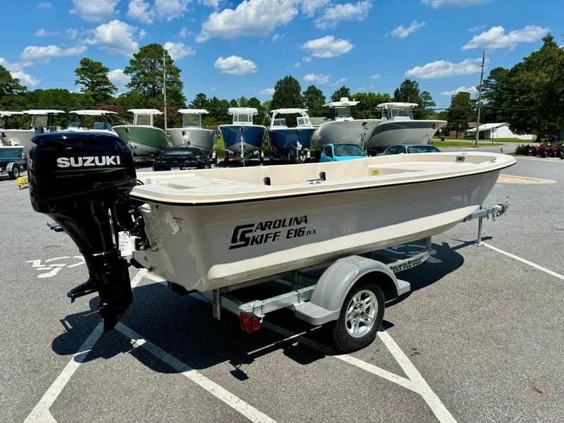 Slide: The Image of 2025 Carolina Skiff EV16 JVX TH boat with Suzuki outboard motor on a trailer. - 2