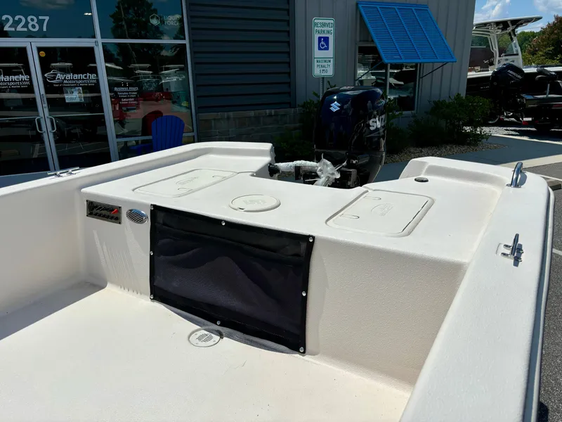 Slide: The Image of 2025 Carolina Skiff EV16 JVX TH boat with Suzuki outboard motor, parked outside a dealership. - 4
