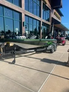 Slide: The Image of 2024 Nitro Z18 boat displayed outside a store, on a trailer. - 3