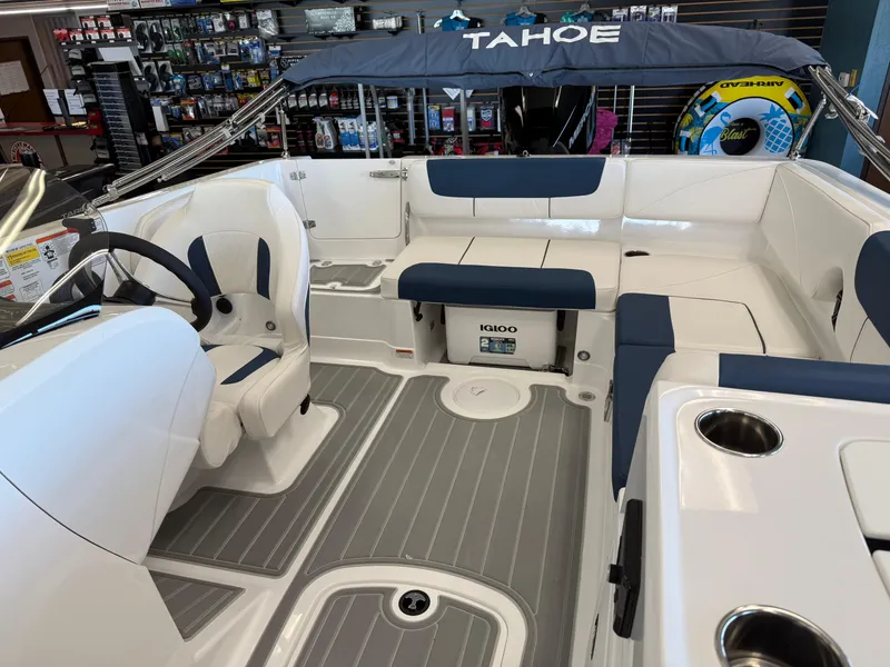 Slide: The Image of 2024 Tahoe 2150 boat interior with seating, steering wheel, and cup holders. - 3