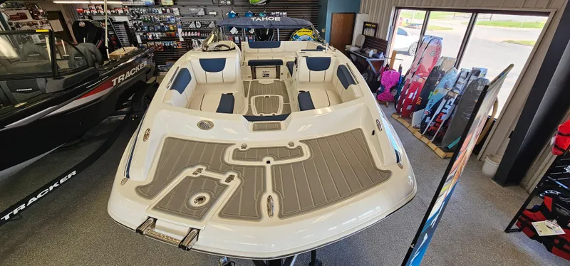 Slide: The Image of 2024 Tahoe 2150 boat displayed in showroom with seating and deck features. - 4
