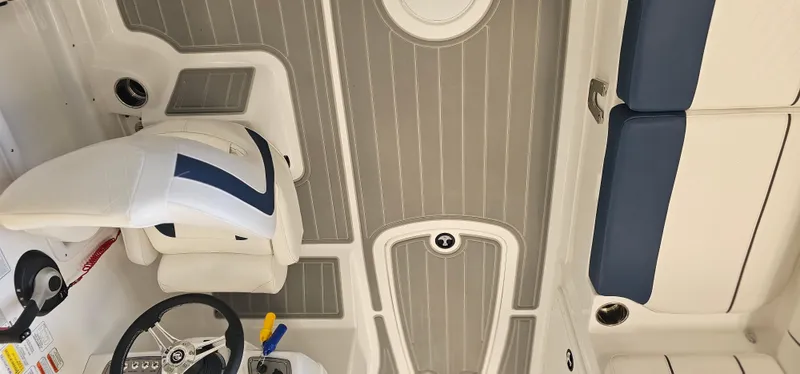 Slide: The Image of 2024 Tahoe 2150 boat interior with steering wheel and seating, featuring modern design elements. - 7