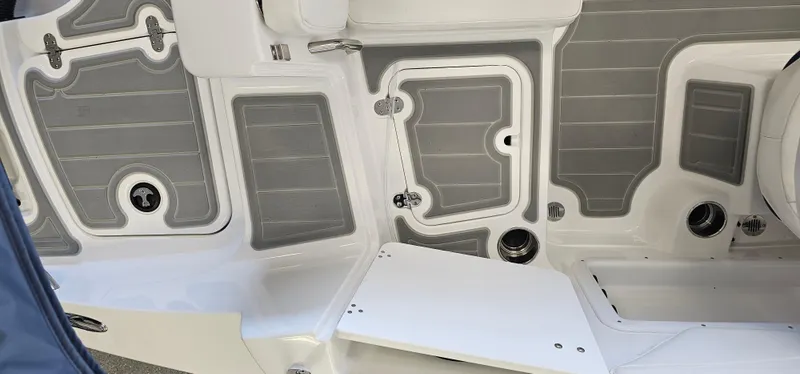 Slide: The Image of 2024 Tahoe 2150 boat interior with gray and white deck design. - 8