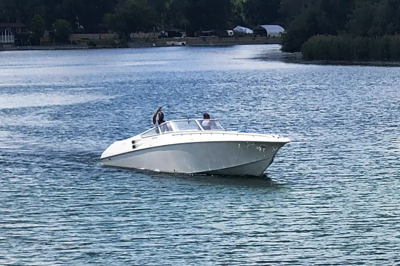 Slide: The Image of A 1999 Fountain 42 Staggered boat cruising on a calm lake. - 2