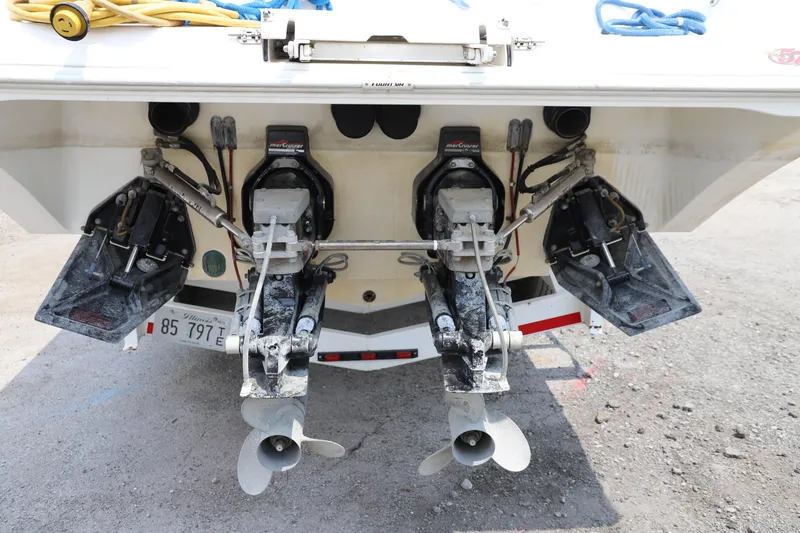 Slide: The Image of 1999 Fountain 42 Staggered boat with dual outboard motors and propellers, rear view. - 21