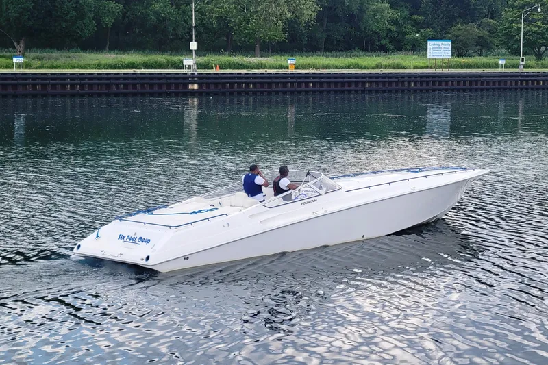 Slide: The Image of 1999 Fountain 42 Staggered speedboat cruising on a calm waterway. - 3