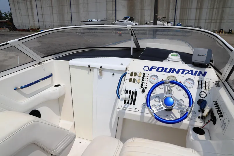 Slide: The Image of 1999 Fountain 42 Staggered boat cockpit with steering wheel and control panel. - 40