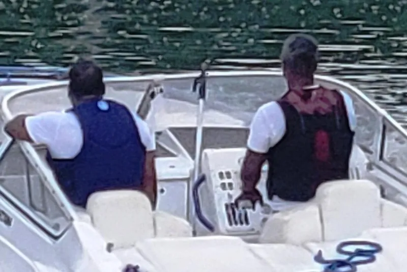 Slide: The Image of Two people in life vests on a 1999 Fountain 42 Staggered boat. - 7