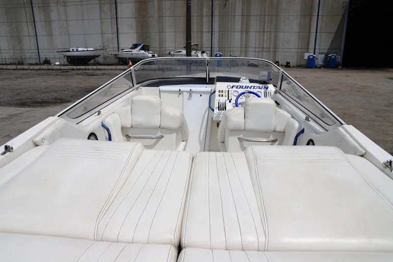 Slide: The Image of 1999 Fountain 42 Staggered boat interior with white seating and dashboard. - 8