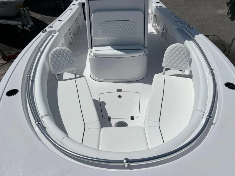 Slide: The Image of 2024 Sportsman Open 232 Center Console boat with white cushioned seating. - 10