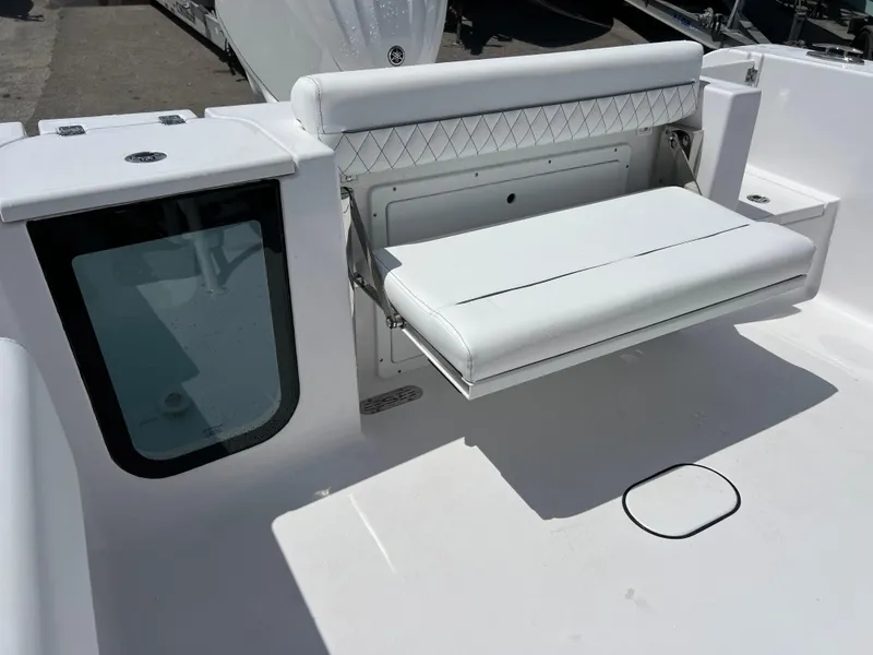 Slide: The Image of 2024 Sportsman Open 232 Center Console boat with foldable rear seat. - 14