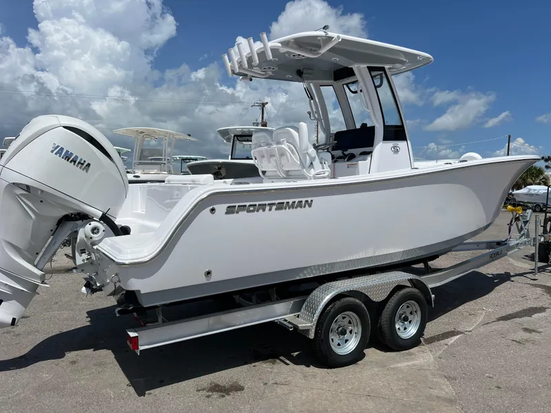 Slide: The Image of 2024 Sportsman Open 232 Center Console boat on trailer with Yamaha engine. - 2