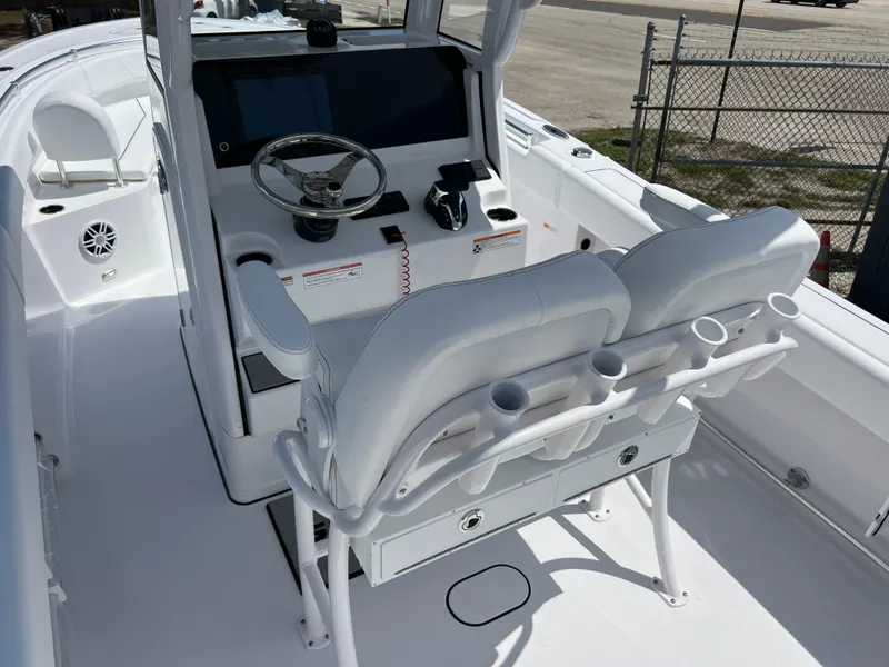 Slide: The Image of 2024 Sportsman Open 232 Center Console boat interior with dual helm seats and modern dashboard. - 6