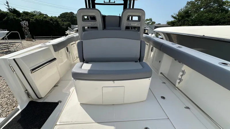 Slide: The Image of 2025 Boston Whaler 330 Outrage boat interior with seating and storage. - 11