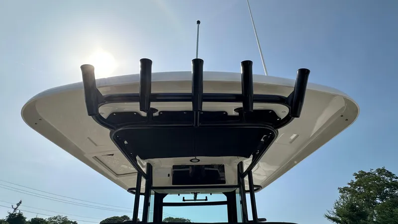 Slide: The Image of Boston Whaler 330 Outrage 2025 boat, viewed from below, with clear sky background. - 15