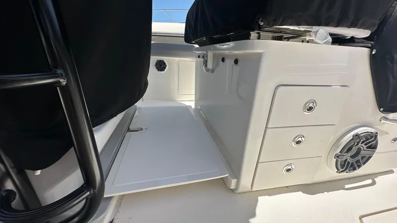 Slide: The Image of 2025 Boston Whaler 330 Outrage interior with storage compartments and speaker. - 19