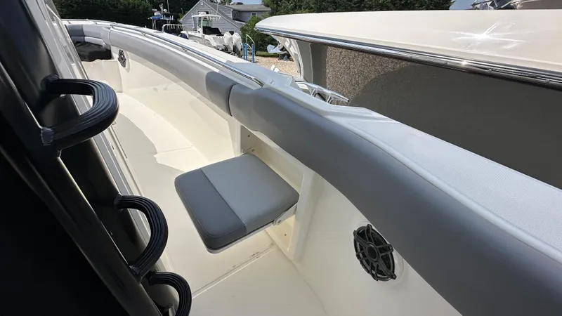 Slide: The Image of 2025 Boston Whaler 330 Outrage boat interior with seating and speaker detail. - 27