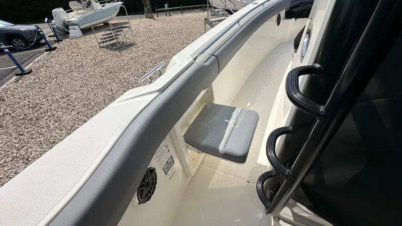 Slide: The Image of 2025 Boston Whaler 330 Outrage boat interior with seating and railing. - 28