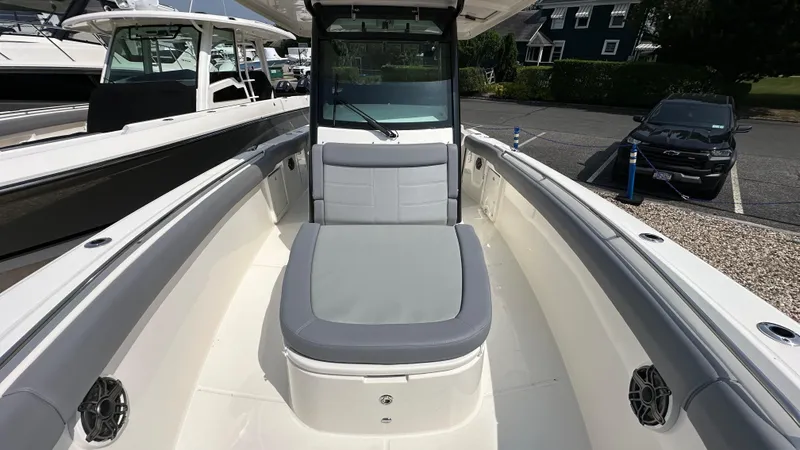 Slide: The Image of 2025 Boston Whaler 330 Outrage boat interior with cushioned seating and sleek design. - 29