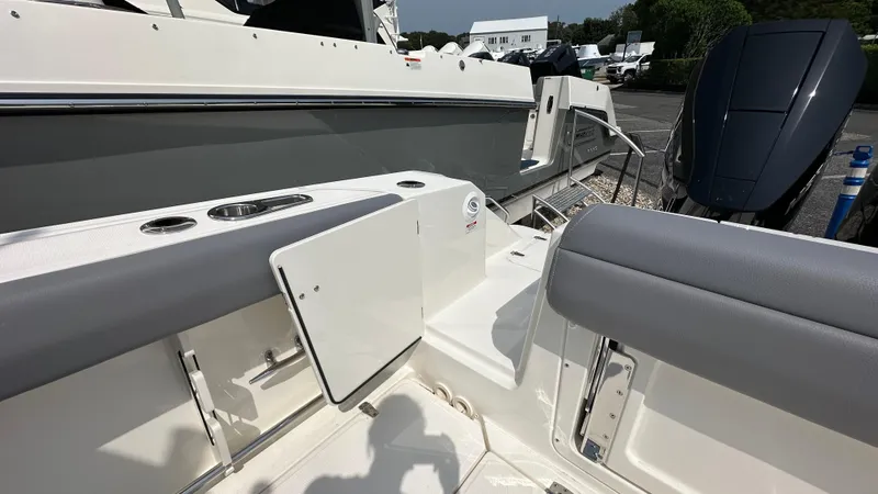 Slide: The Image of 2025 Boston Whaler 330 Outrage boat interior with seating and storage compartments. - 3