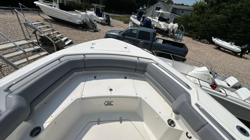 Slide: The Image of 2025 Boston Whaler 330 Outrage boat interior with seating, parked in a marina. - 31
