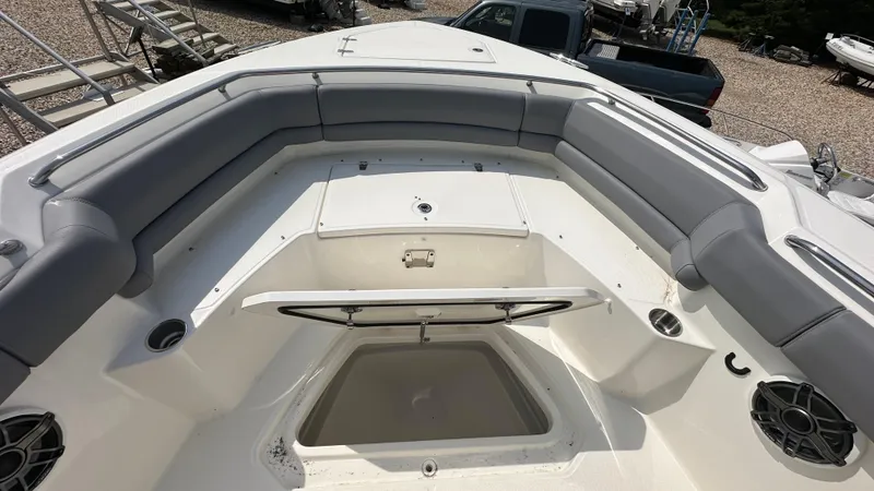 Slide: The Image of 2025 Boston Whaler 330 Outrage boat interior with cushioned seating and storage compartments. - 33