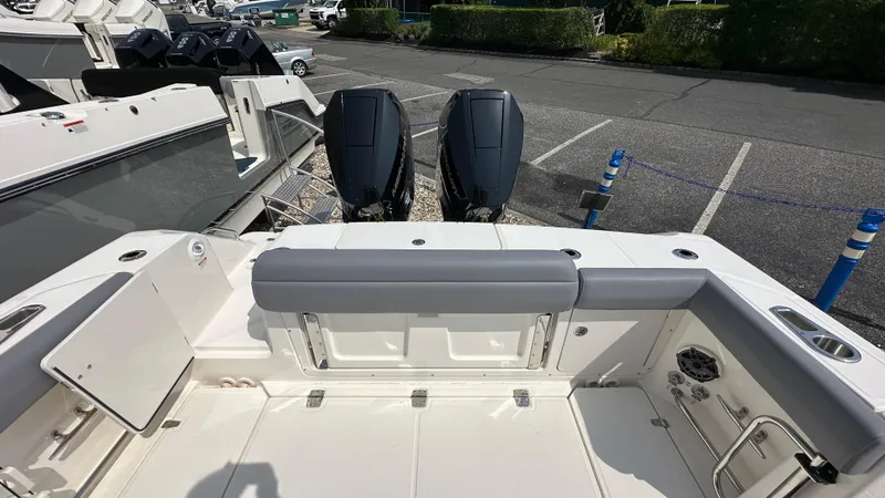 Slide: The Image of 2025 Boston Whaler 330 Outrage boat deck with dual outboard engines. - 5