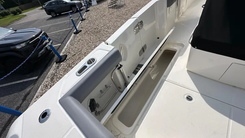Slide: The Image of 2025 Boston Whaler 330 Outrage boat interior with storage compartments and seating. - 8