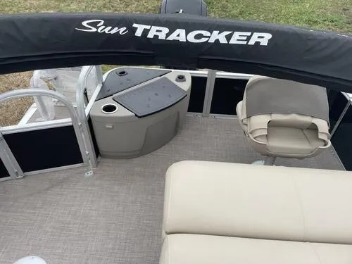 Slide: The Image of 2023 Sun Tracker SportFish 20 DLX pontoon boat interior with seating and console. - 11