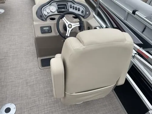 Slide: The Image of 2023 Sun Tracker SportFish 20 DLX boat helm with beige captain's chair and control panel. - 13