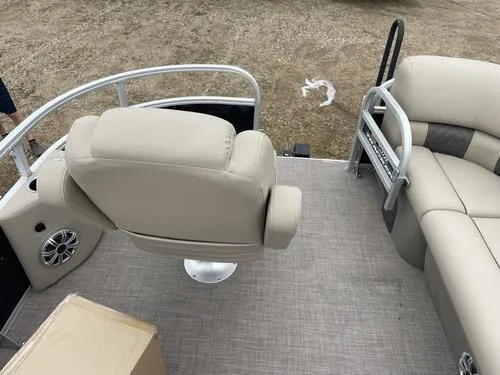 Slide: The Image of 2023 Sun Tracker SportFish 20 DLX pontoon boat interior with beige seating. - 5