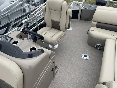 Slide: The Image of 2023 Sun Tracker SportFish 20 DLX interior with beige seating and steering console. - 9