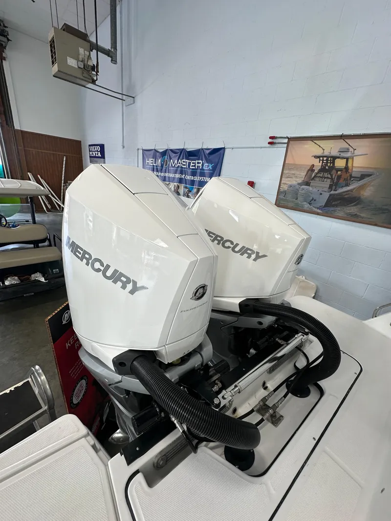 Slide: The Image of 2023 Blackfin 272 CC with twin Mercury outboard engines in a showroom. - 10