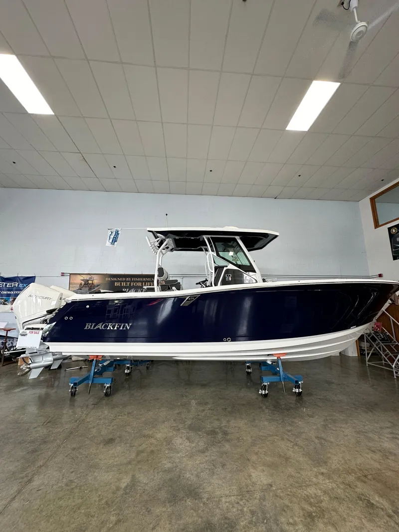 Slide: The Image of 2023 Blackfin 272 CC boat displayed indoors. - 17