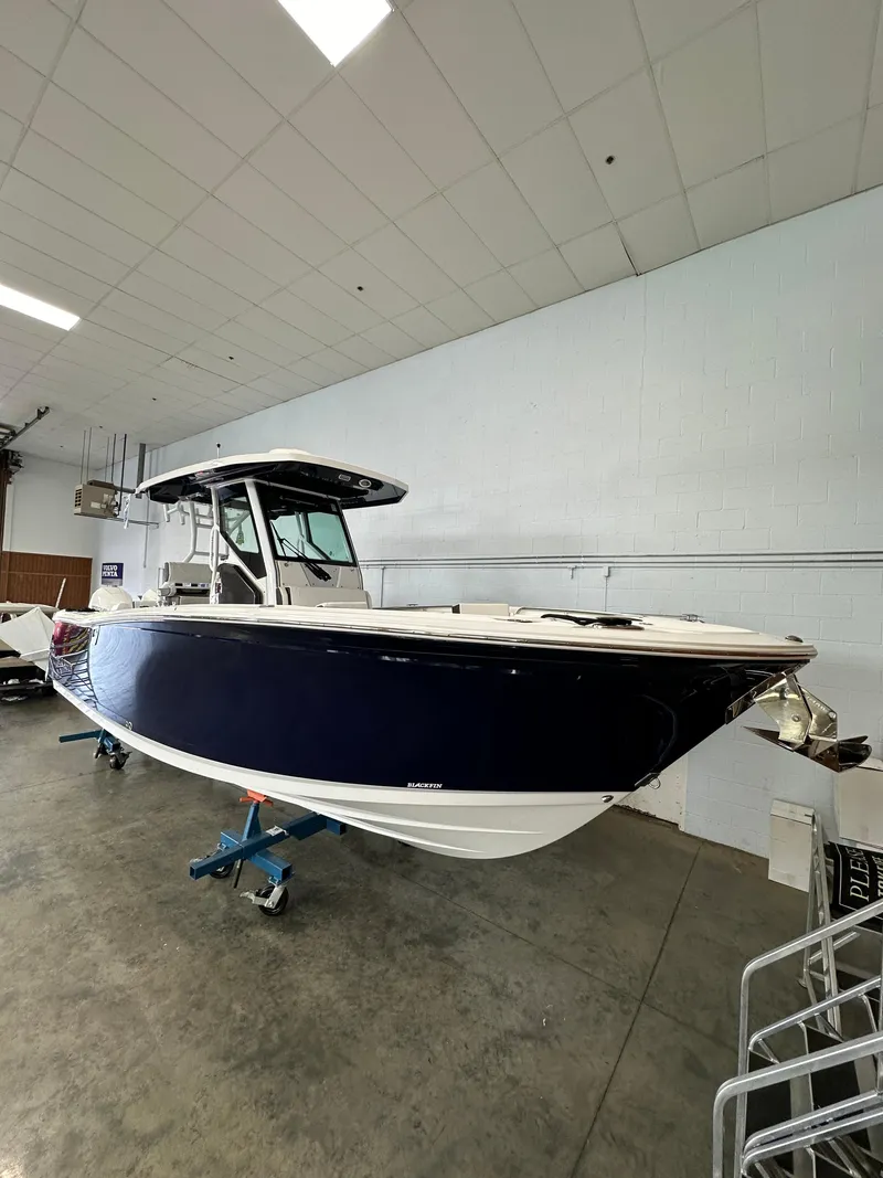 Slide: The Image of 2023 Blackfin 272 CC boat in indoor showroom. - 18