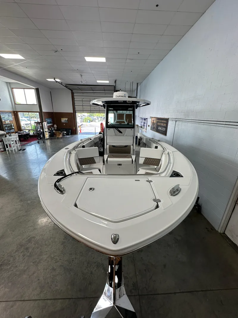 Slide: The Image of 2023 Blackfin 272 CC boat displayed in a showroom. - 19