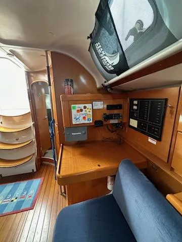 Slide: The Image of Interior of a 1997 Beneteau 42S7 sailboat with navigation station and seating area. - 12