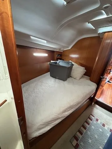 Slide: The Image of Cozy cabin interior of 1997 Beneteau 42S7 sailboat with bed and storage bin. - 15