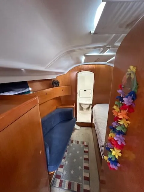 Slide: The Image of Interior of 1997 Beneteau 42S7 sailboat with cozy cabin and colorful decor. - 18