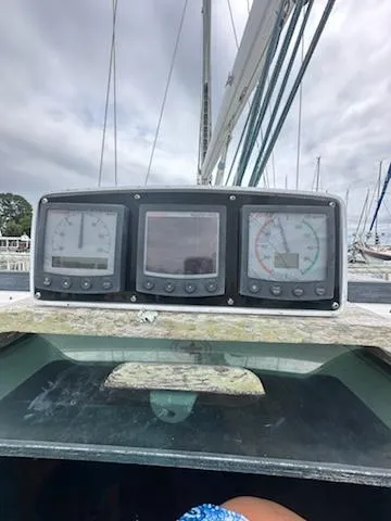 Slide: The Image of Beneteau 42S7 1997 sailboat cockpit instruments with cloudy sky background. - 2