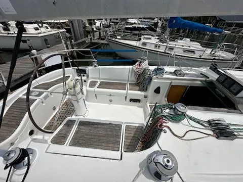 Slide: The Image of 1997 Beneteau 42S7 sailboat cockpit with steering wheel and mooring lines. - 5