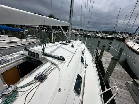 Slide: The Image of 1997 Beneteau 42S7 sailboat docked at marina under cloudy skies. - 6