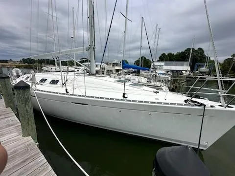 Slide: The Image of 1997 Beneteau 42S7 sailboat docked at marina under cloudy skies. - 7