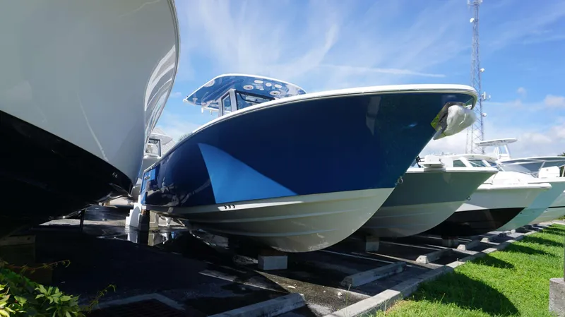 Slide: The Image of 2025 Sportsman 261 Heritage boat displayed outdoors under clear blue sky. - 1