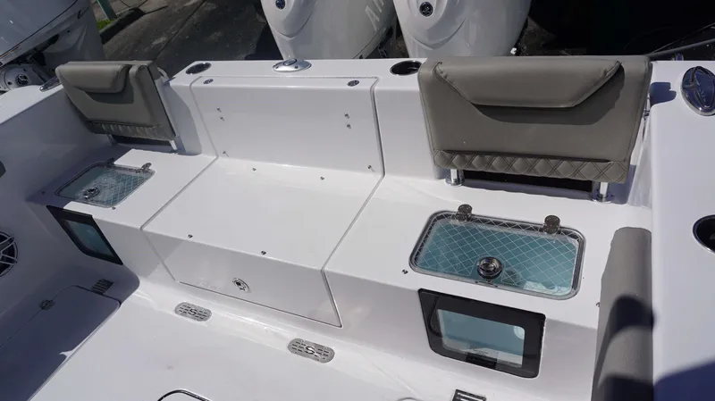 Slide: The Image of 2025 Sportsman 261 Heritage boat interior with seating and storage compartments. - 12