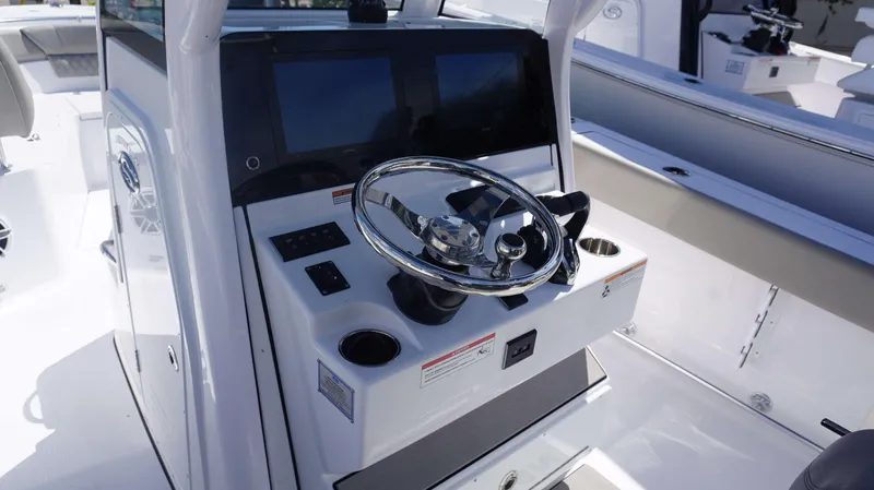 Slide: The Image of 2025 Sportsman 261 Heritage boat console with steering wheel and digital displays. - 14